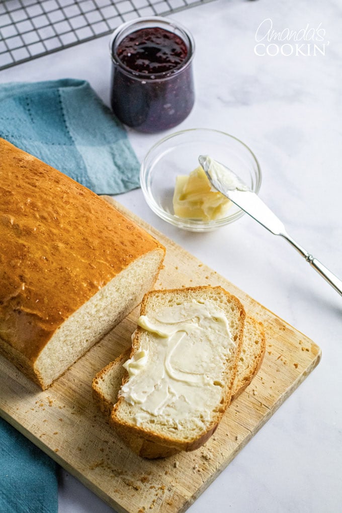 overhead view of bread with a slice that's buttered