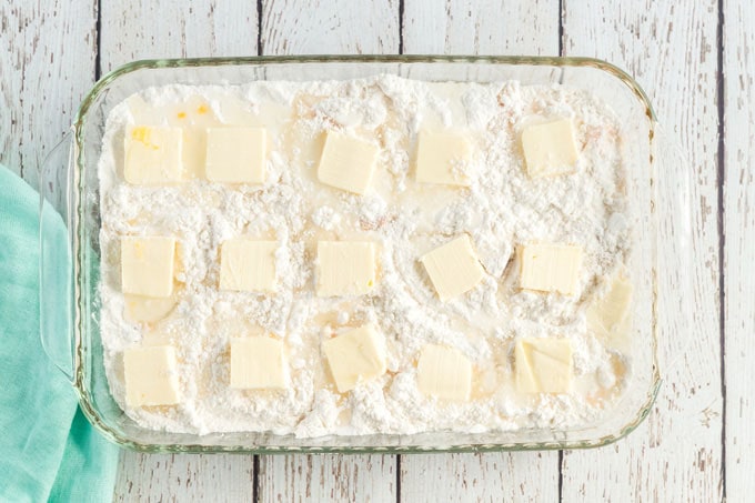 peach dump cake with butter pats on top
