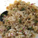 A close up photo of tomato herb pasta salad.
