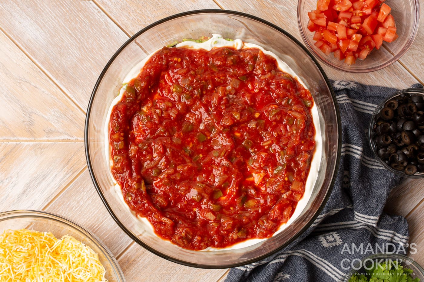 salsa on top of sour cream in a bowl
