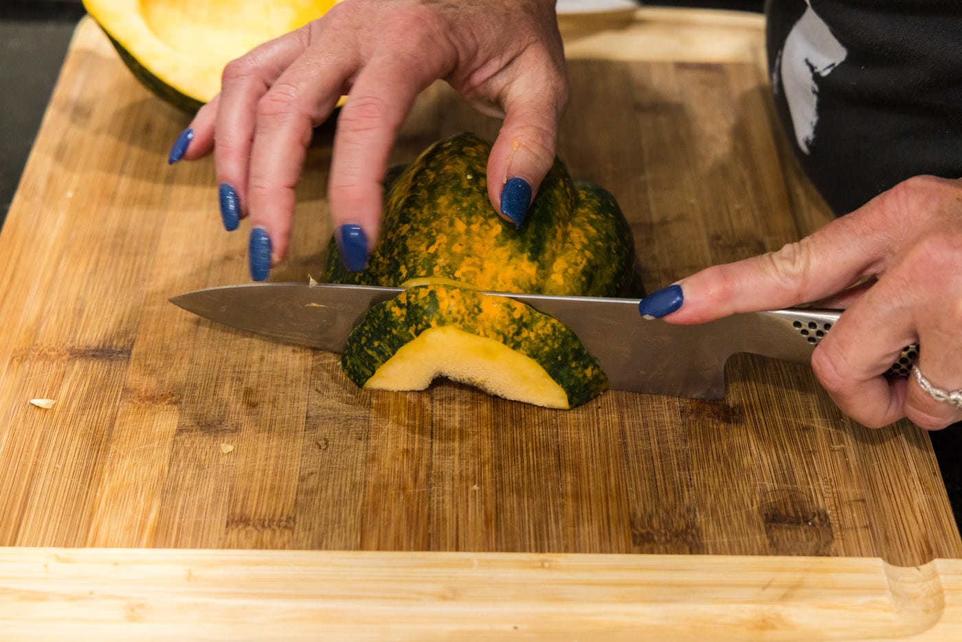 slicing acorn squash into half moon shapes