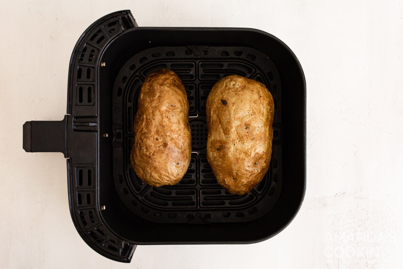 cooked russet potatoes in air fryer basket