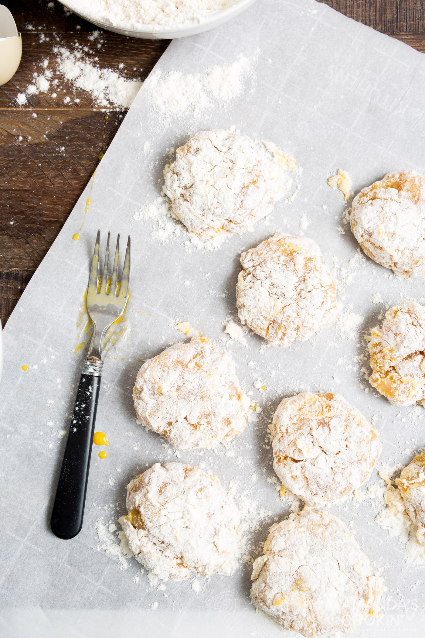 four coated chicken nuggets on parchment