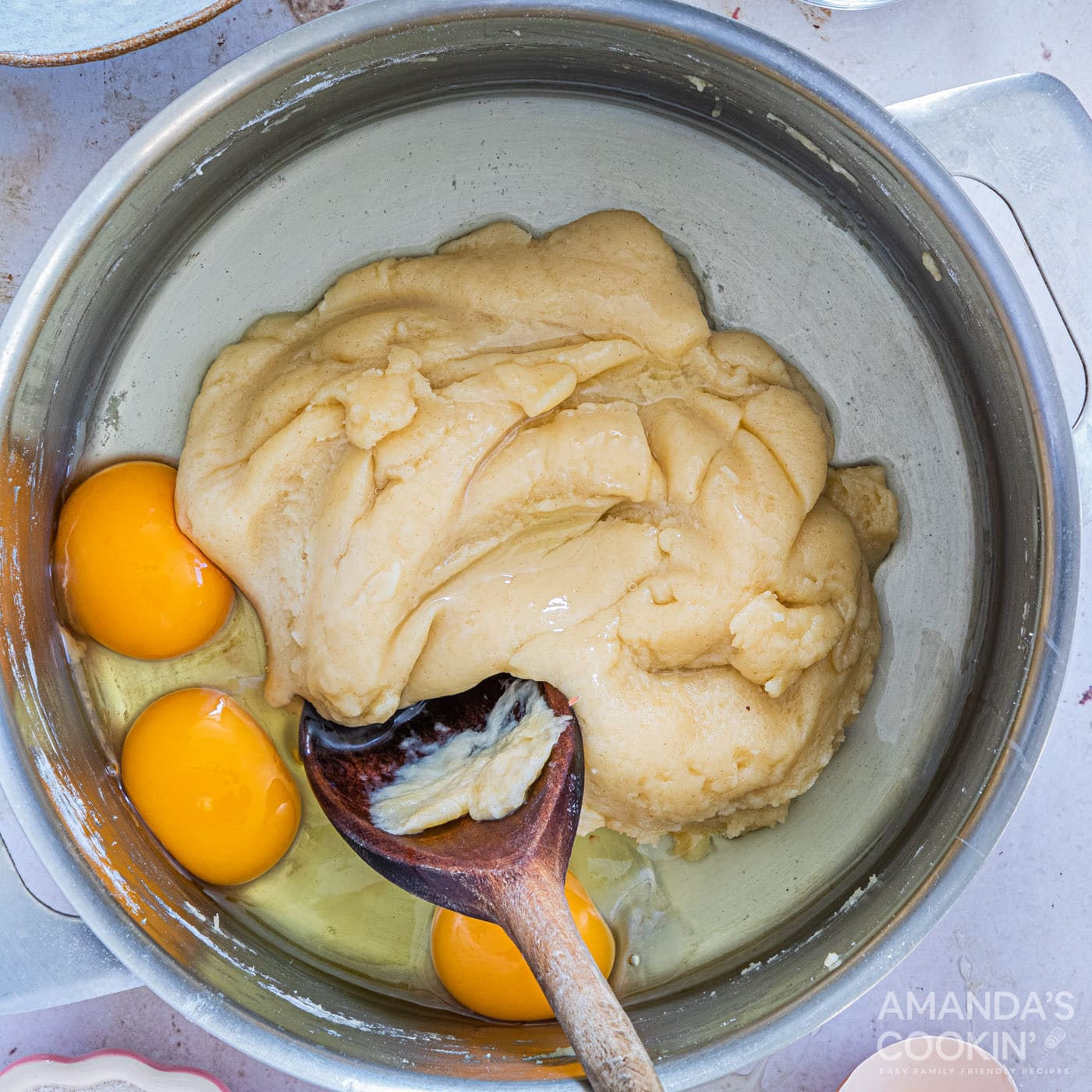 stirring eggs into dough batter