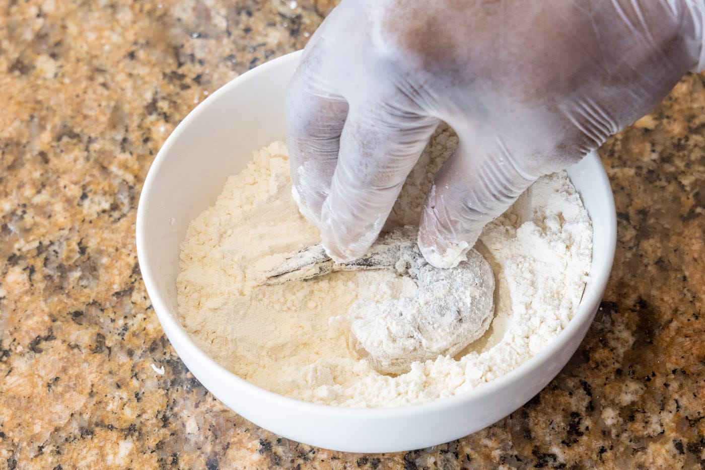 dipping shrimp into flour