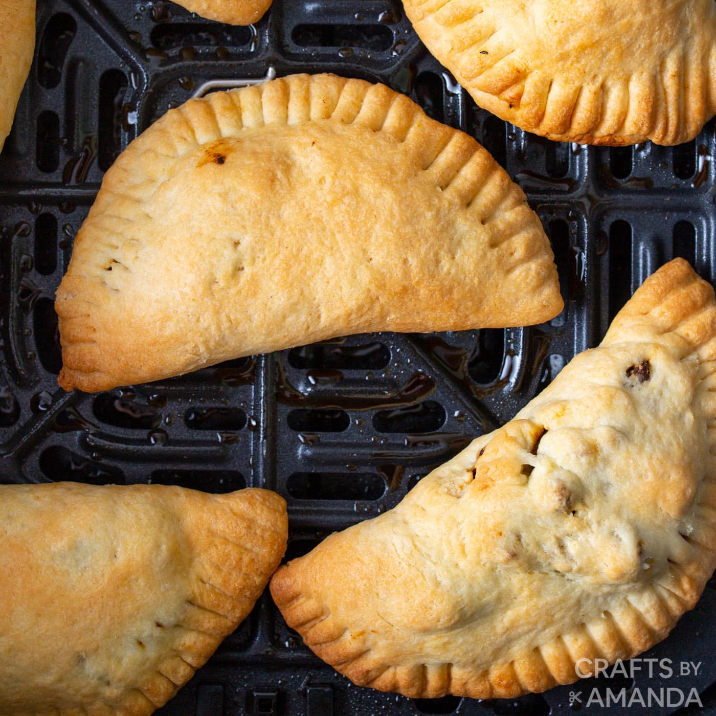 empanadas in an air fryer basket