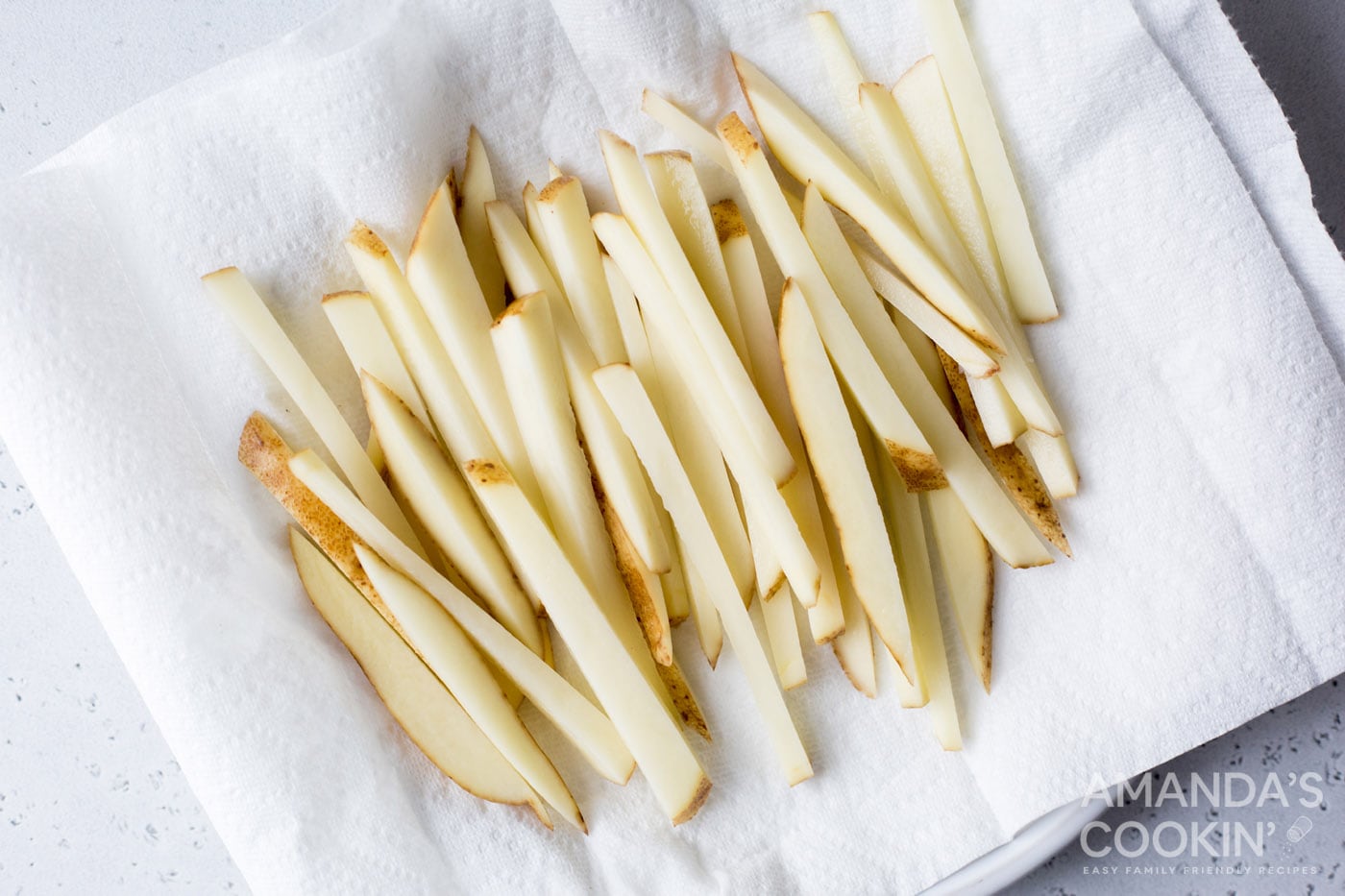 potato slices drying on a paper towel