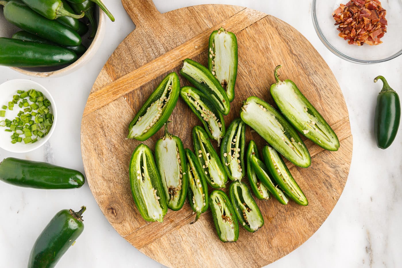 sliced jalapeno peppers on a cutting board