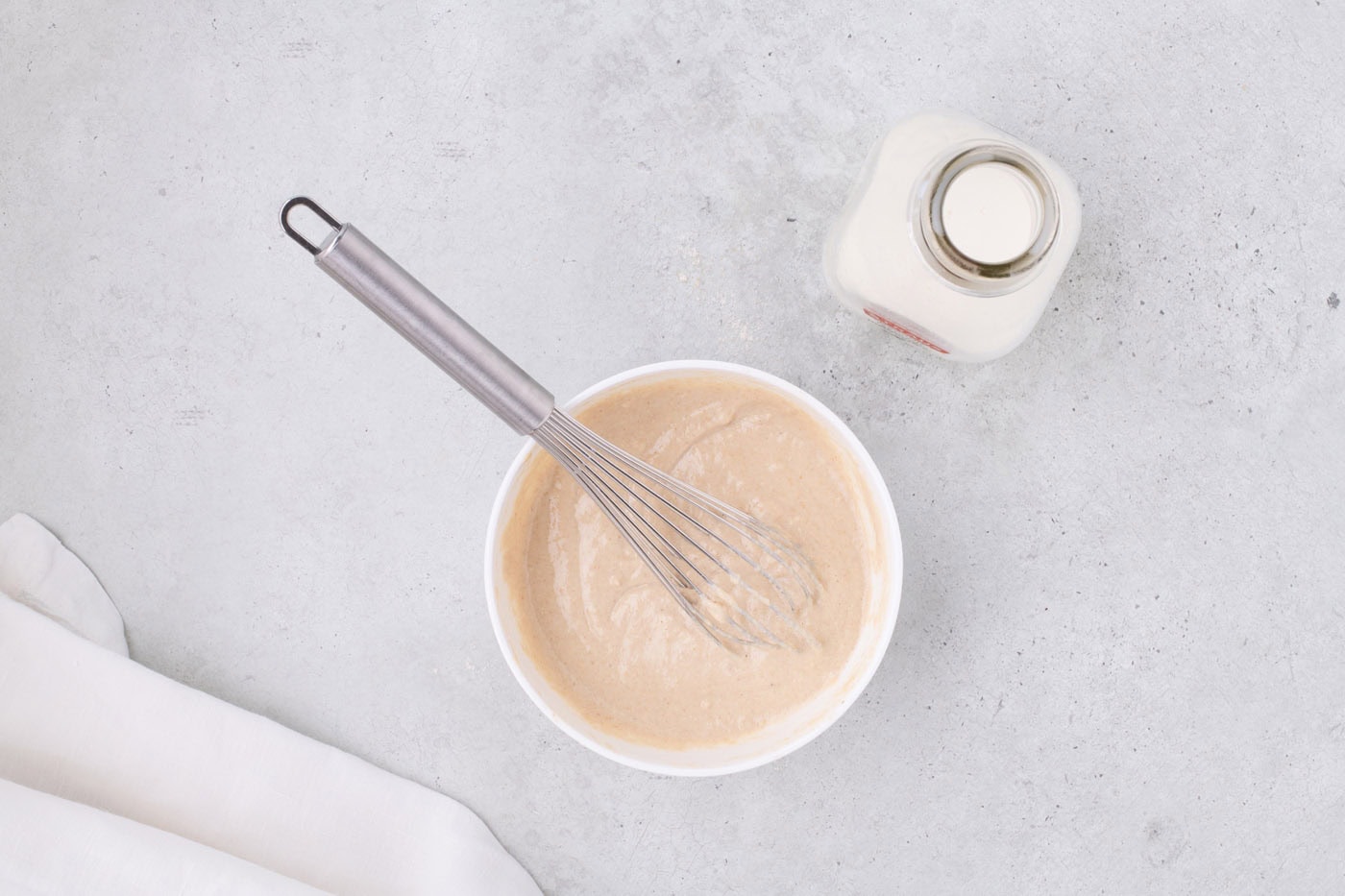 pancake batter mixed in a bowl with a whisk