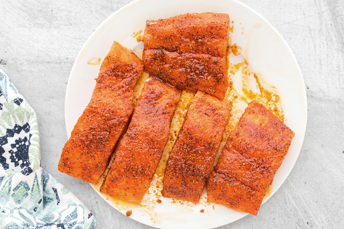 salmon filets coated in seasonings on a plate