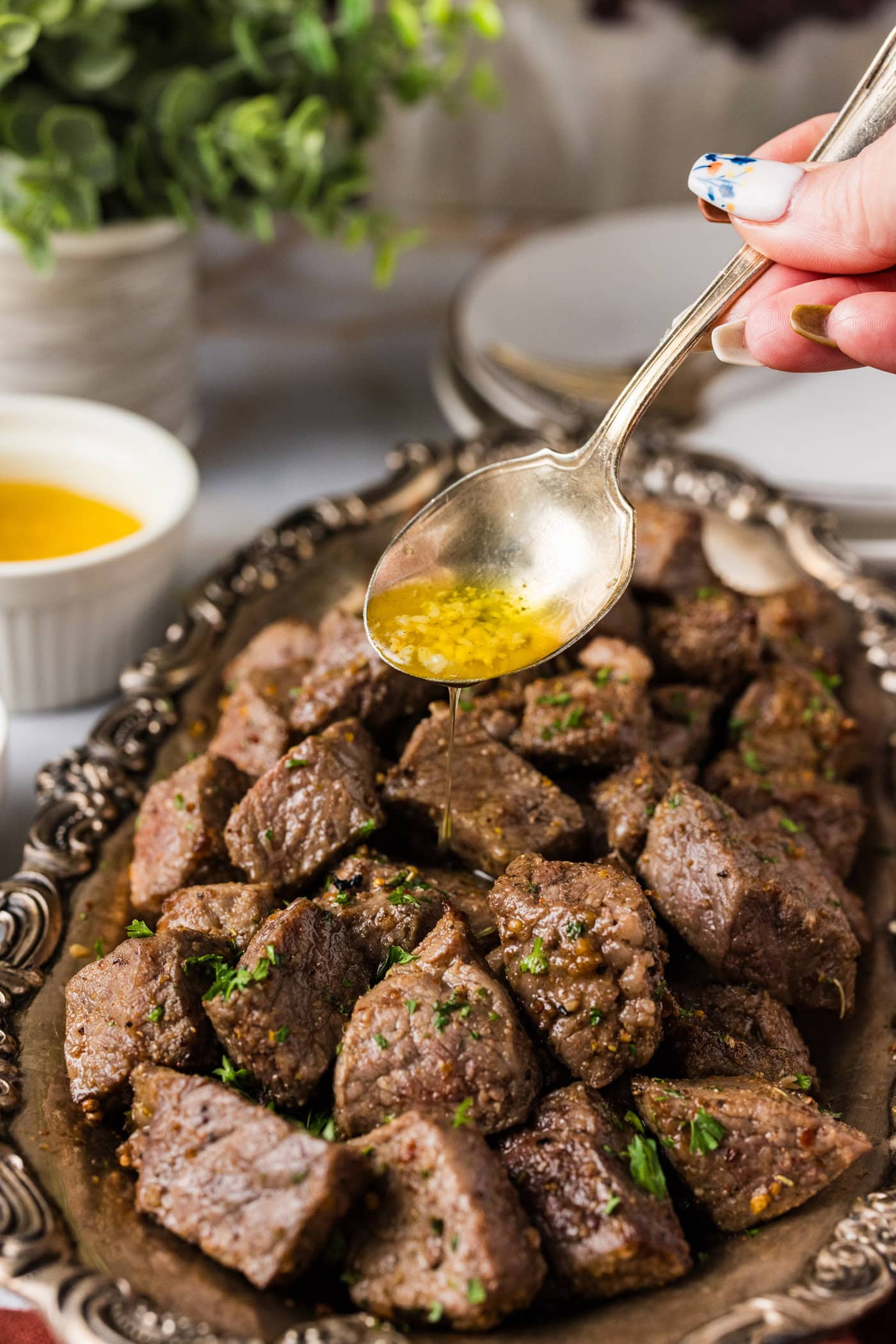 Garlic butter being drizzled over Air Fryer Steak Bites