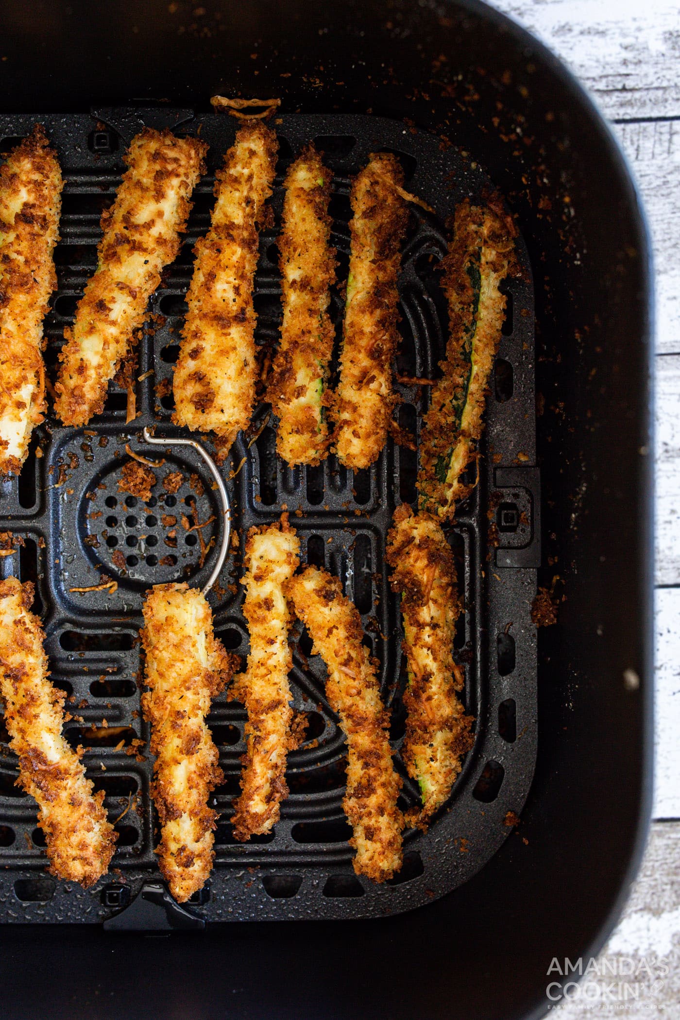 air fryer zucchini fries in an air fryer basket