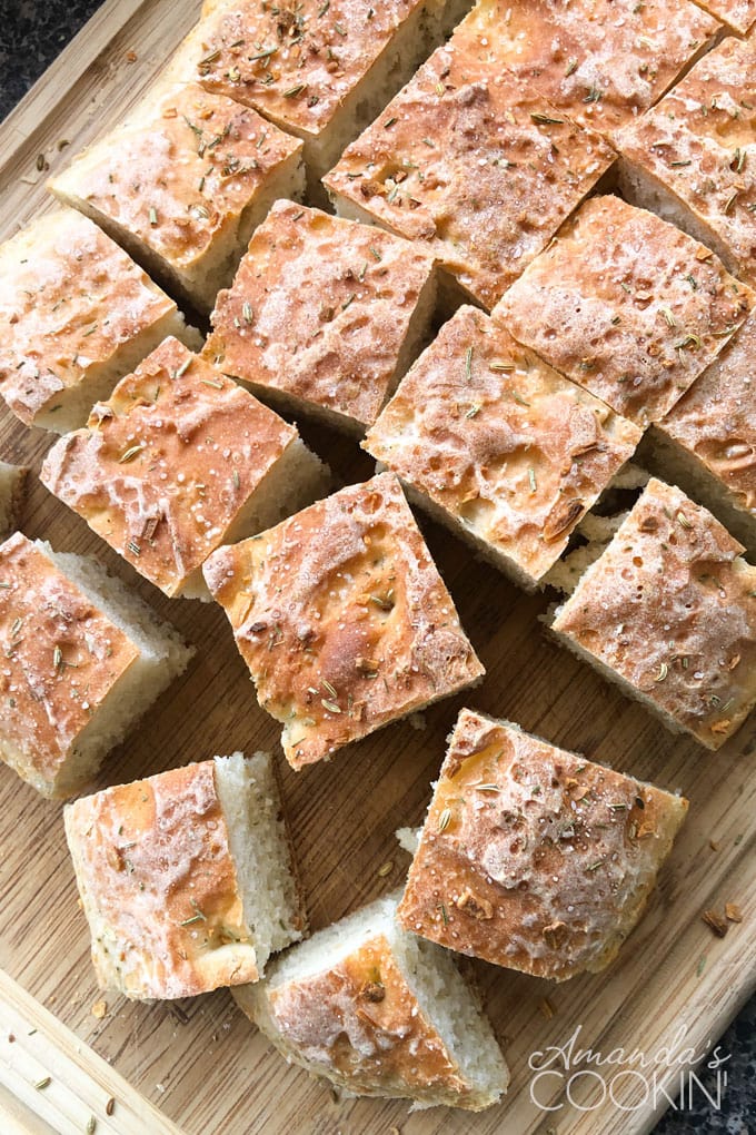 peasant bread cut into squares on a wooden cutting board