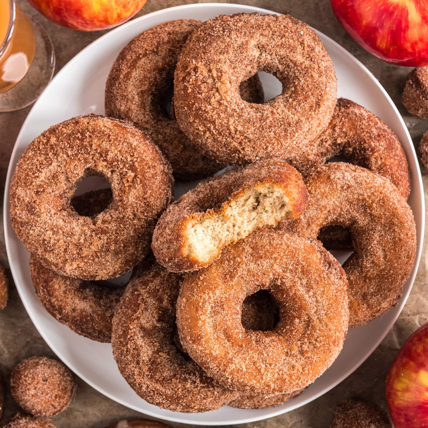 Plate of Apple Cider Doughnuts with a bite taken out of one