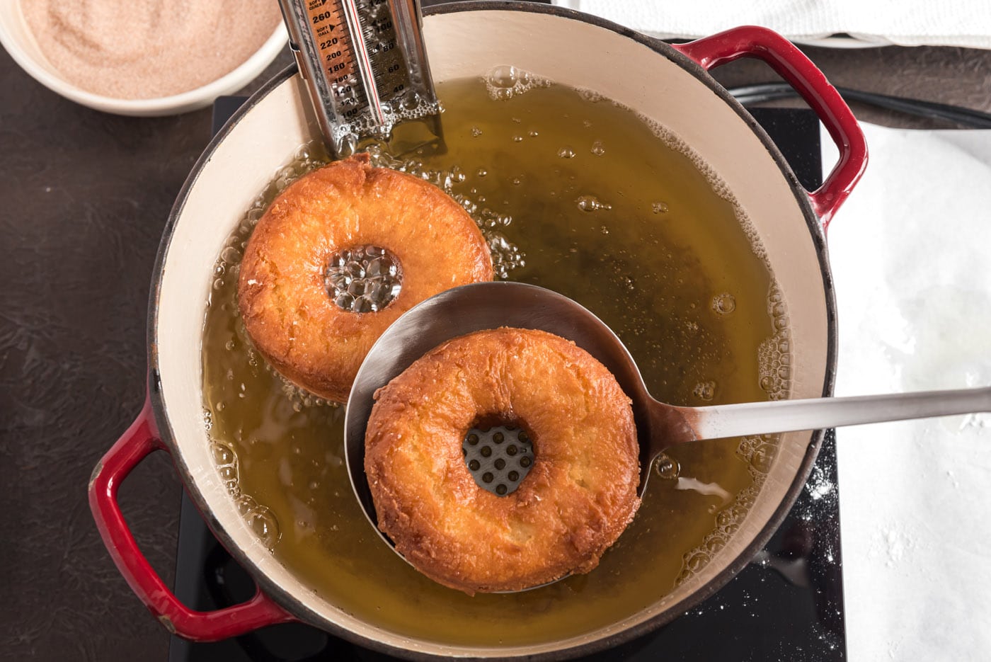 fried donuts being lifted from oil