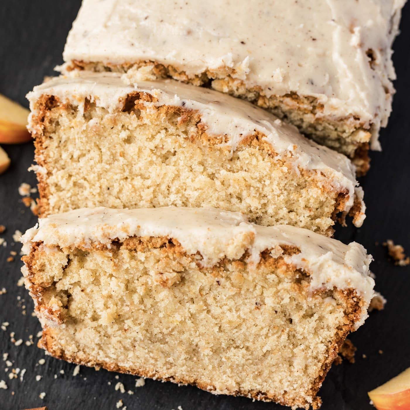 Close up photo of two slices of Apple Cider Pound Cake resting on the loaf