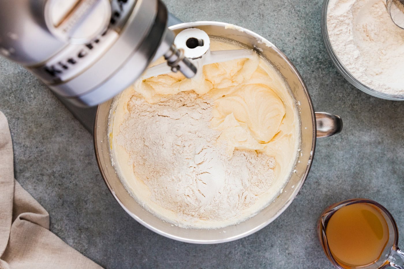 Adding dry ingredients to wet ingredients in a stand mixer bowl
