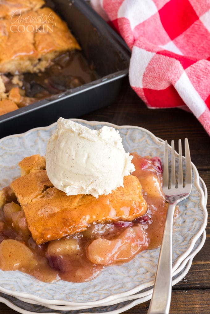 slice of apple crisp with cranberries topped with ice cream