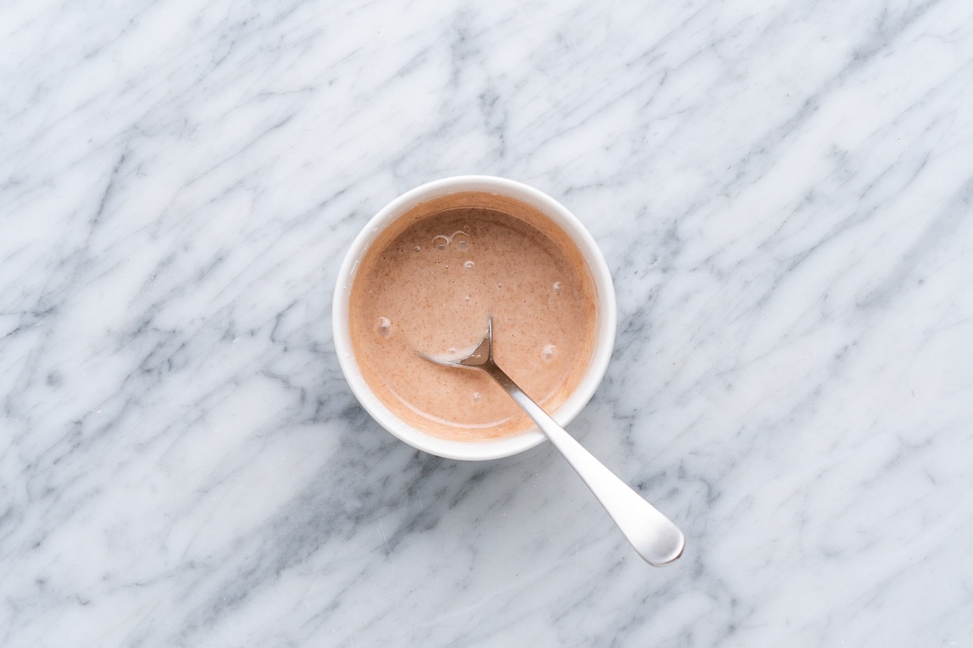 cinnamon glaze in a bowl with spoon