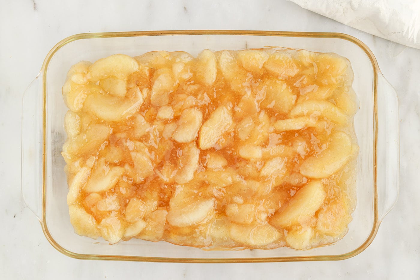 apple pie filling in a glass baking dish