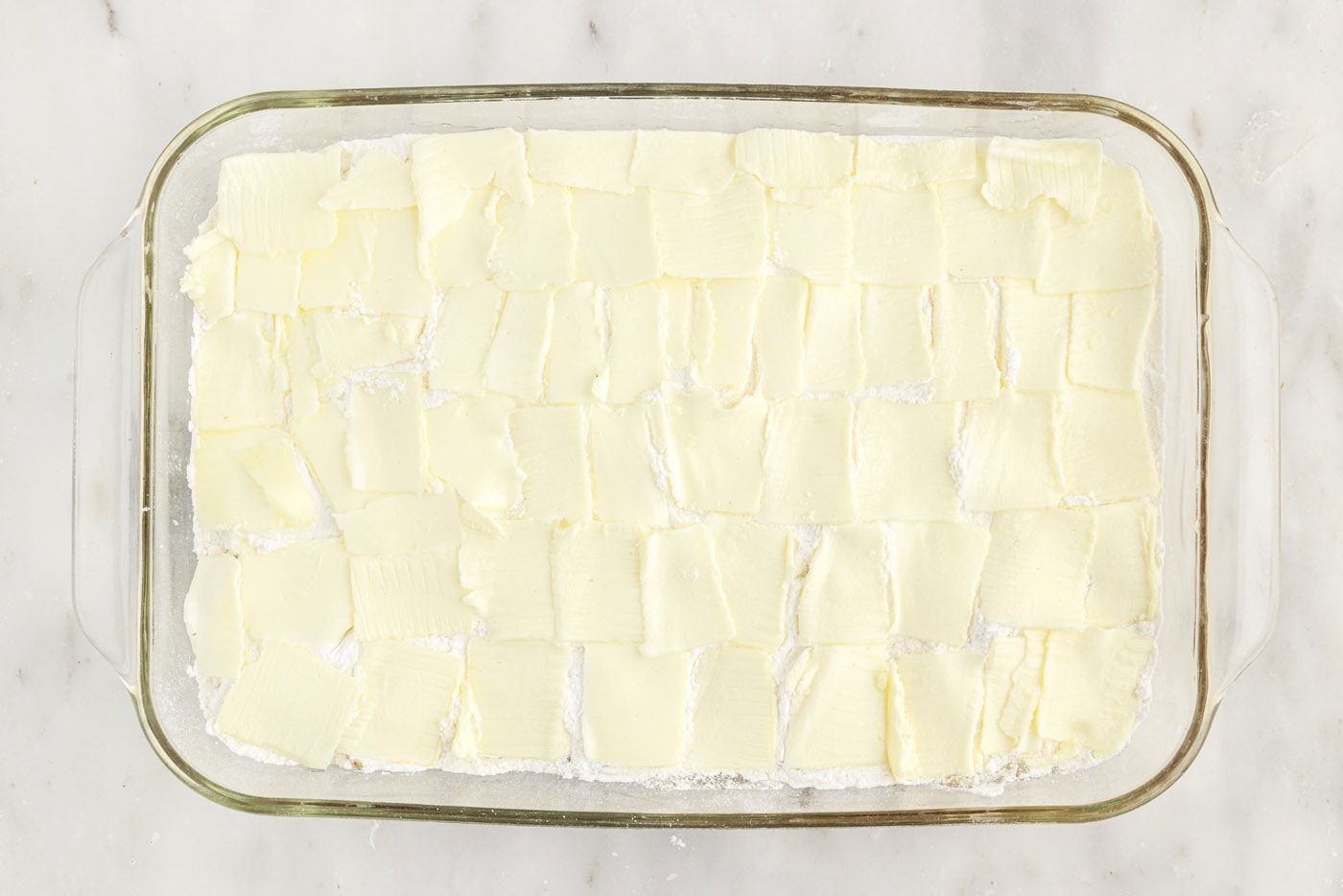 thin pats of butter over the top of cake mix and apple pie filling