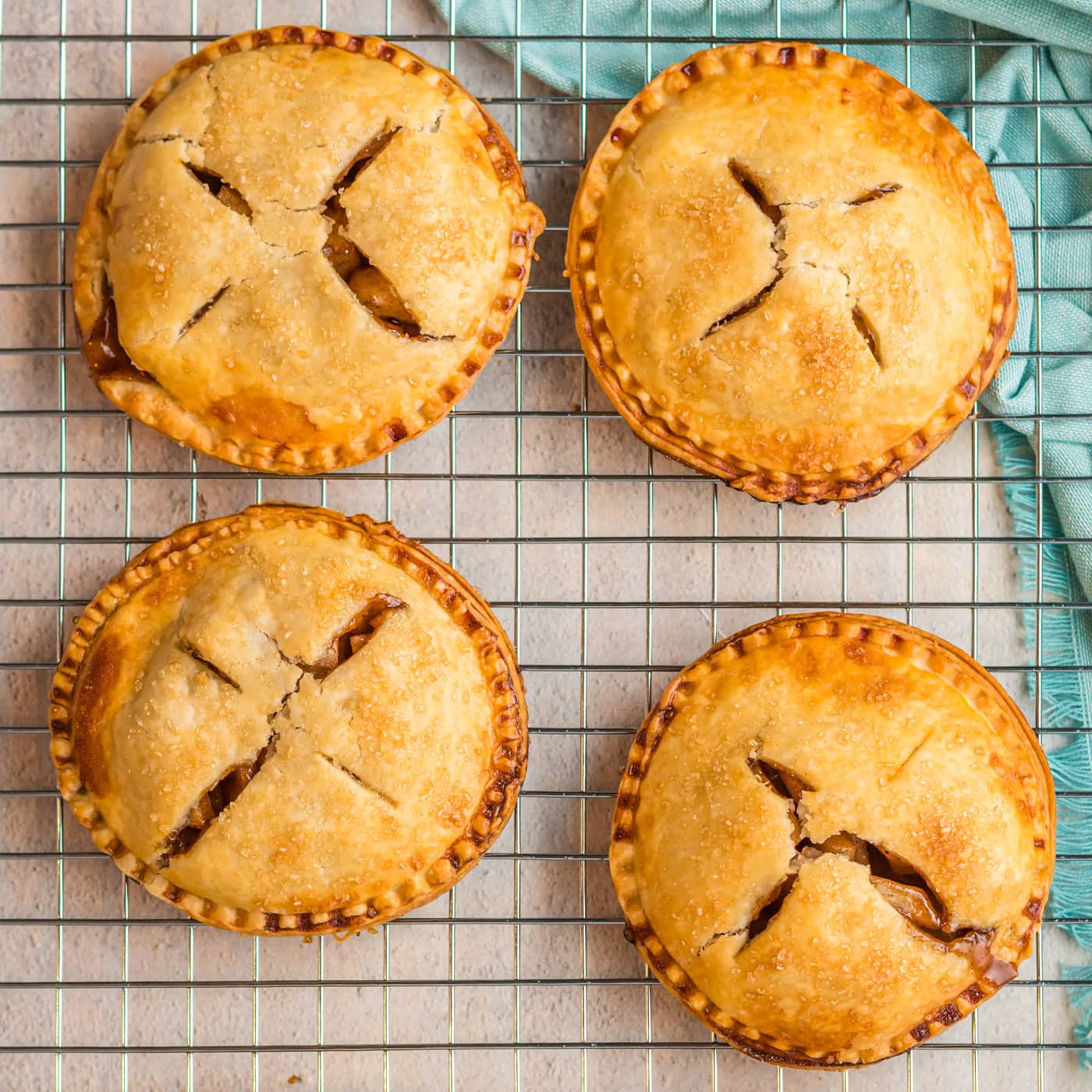 Four Apple Hand Pies on a wire rack