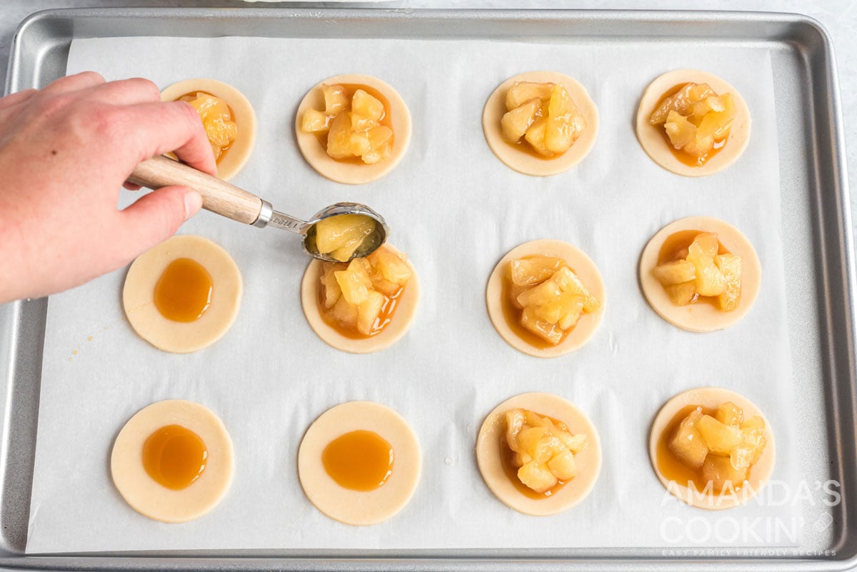 adding apples to caramel