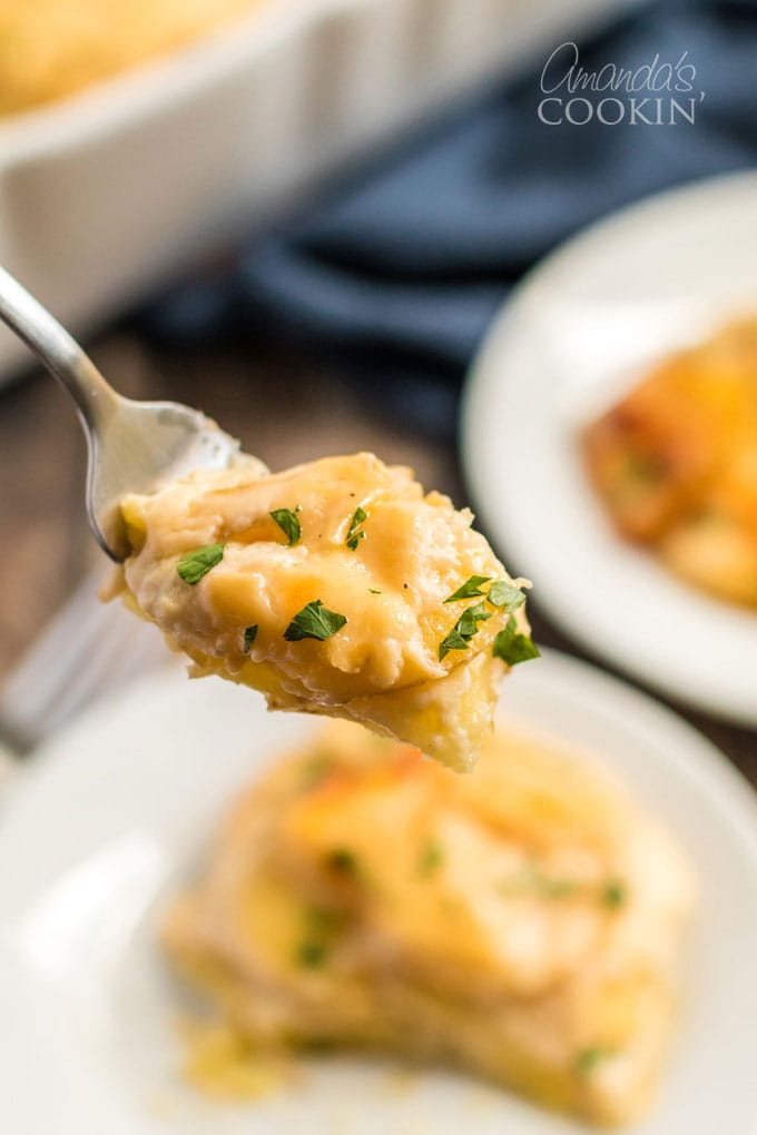 spoon full of scalloped potatoes