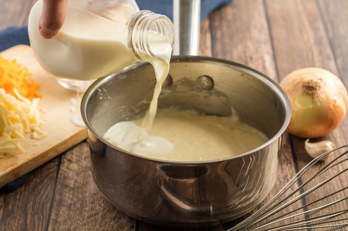 adding milk to saucepan