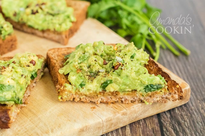 avocado toast with cilantro in background