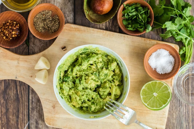 avocado mashed in a bowl with a fork