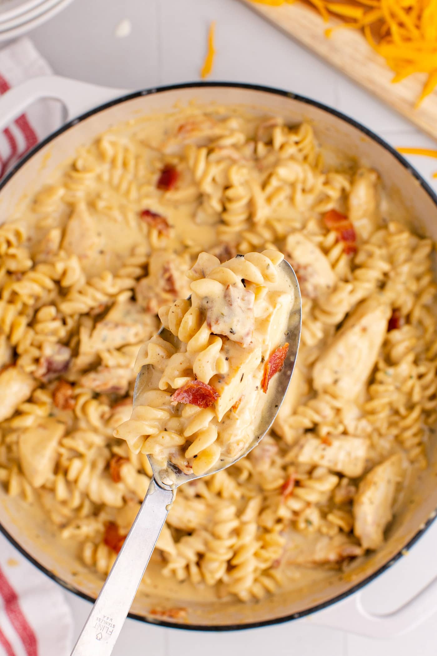 Spoonful of Bacon Chicken Ranch Pasta being lifted out of the pot of Bacon Chicken Ranch Pasta