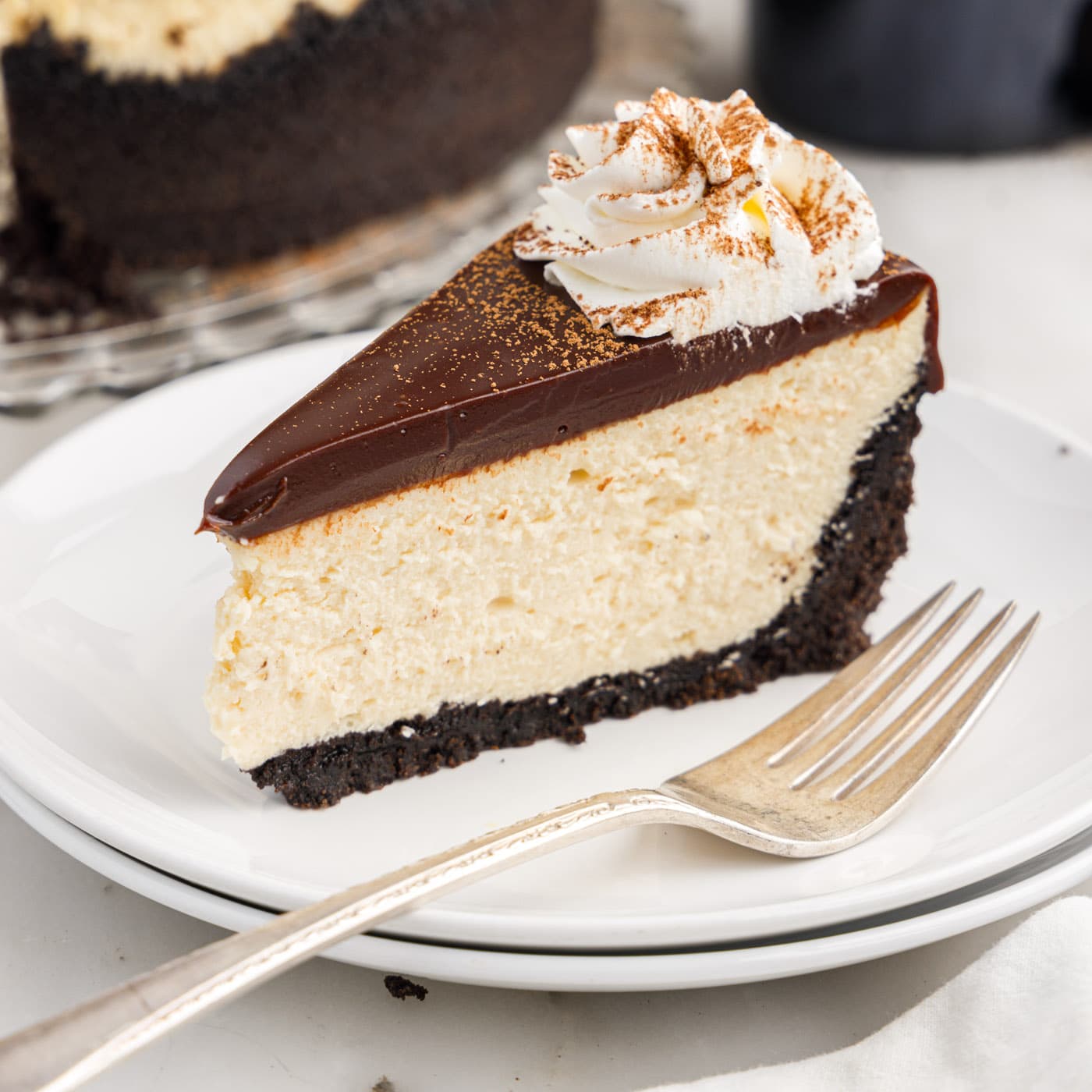 Slice of Baileys Cheesecake on a plate with a fork