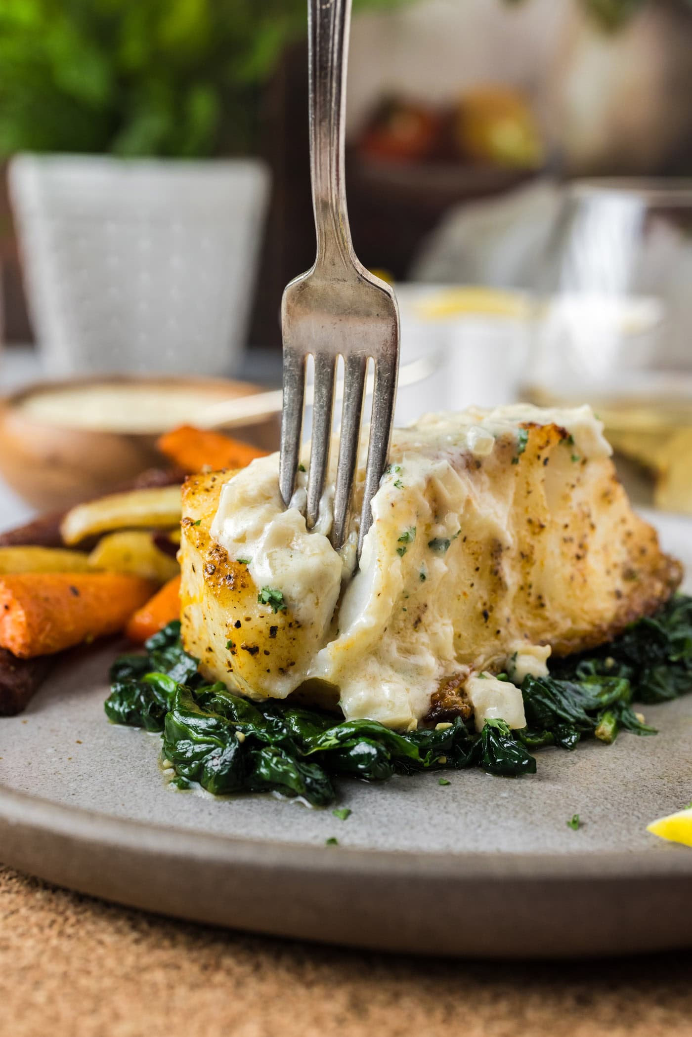 Fork pulling apart a Baked Chilean Sea Bass filet