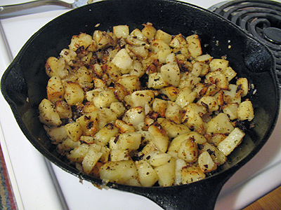 A skillet filled with cubed potatoes.