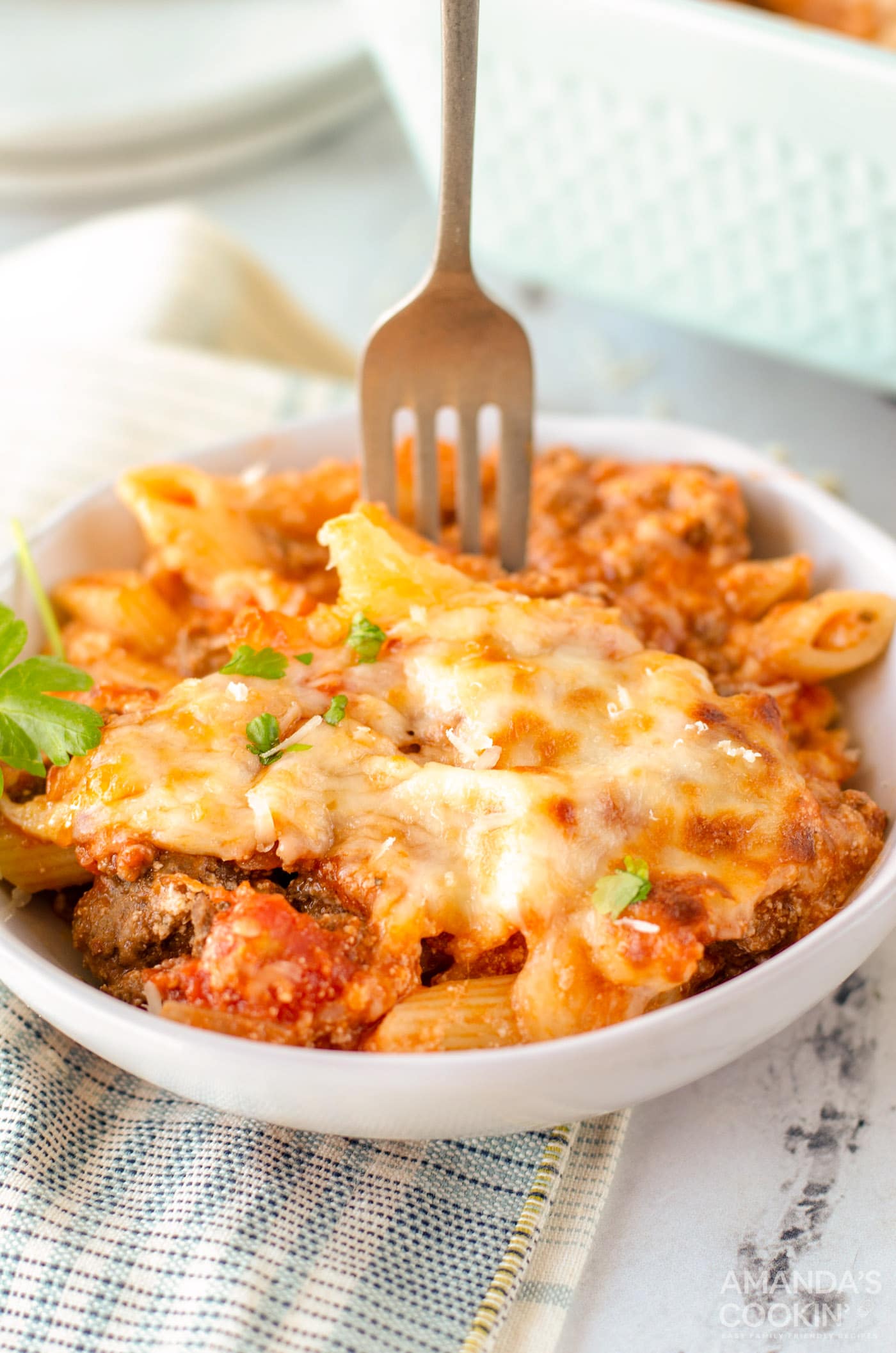 fork in a bowl of baked ziti