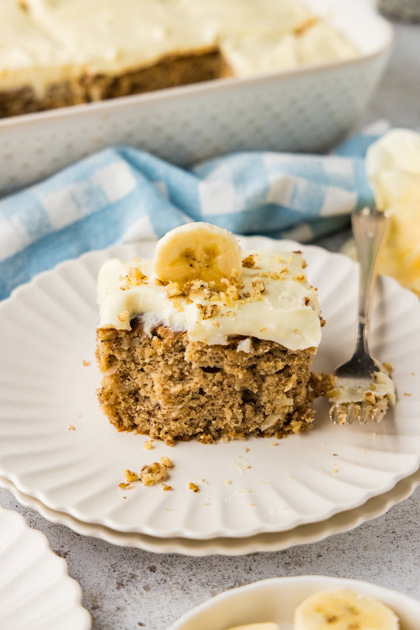slice of Banana Cake with Cream Cheese Frosting on a plate