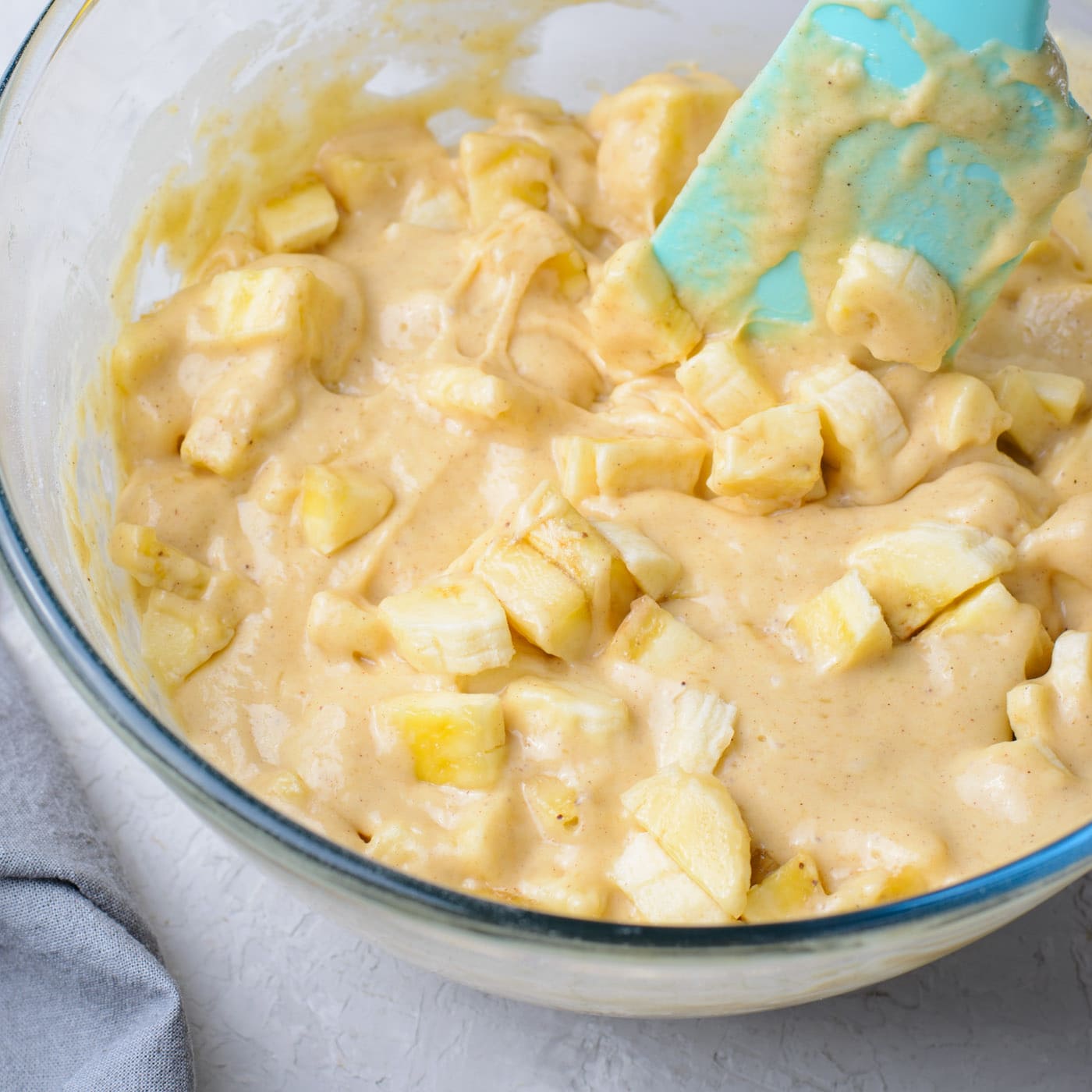 mixing chopped bananas into batter
