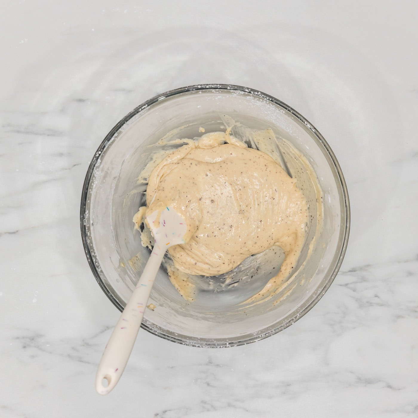 brown butter glaze in a bowl with a rubber spatula