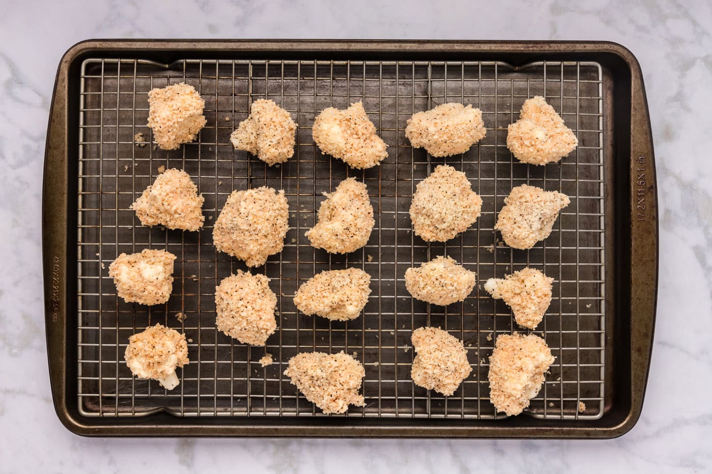panko breadcrumb coated cauliflower florets on a wire rack