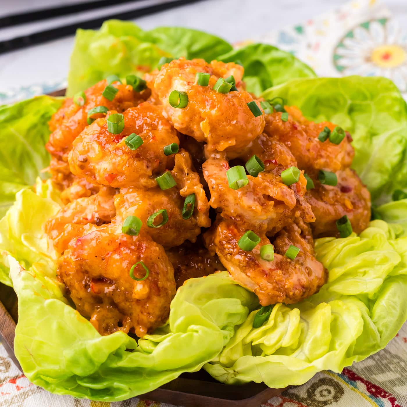 Close up photo of Bang Bang Shrimp on a bed of lettuce