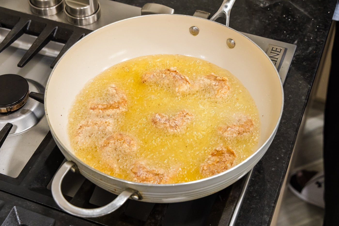 deep frying coated shrimp in oil
