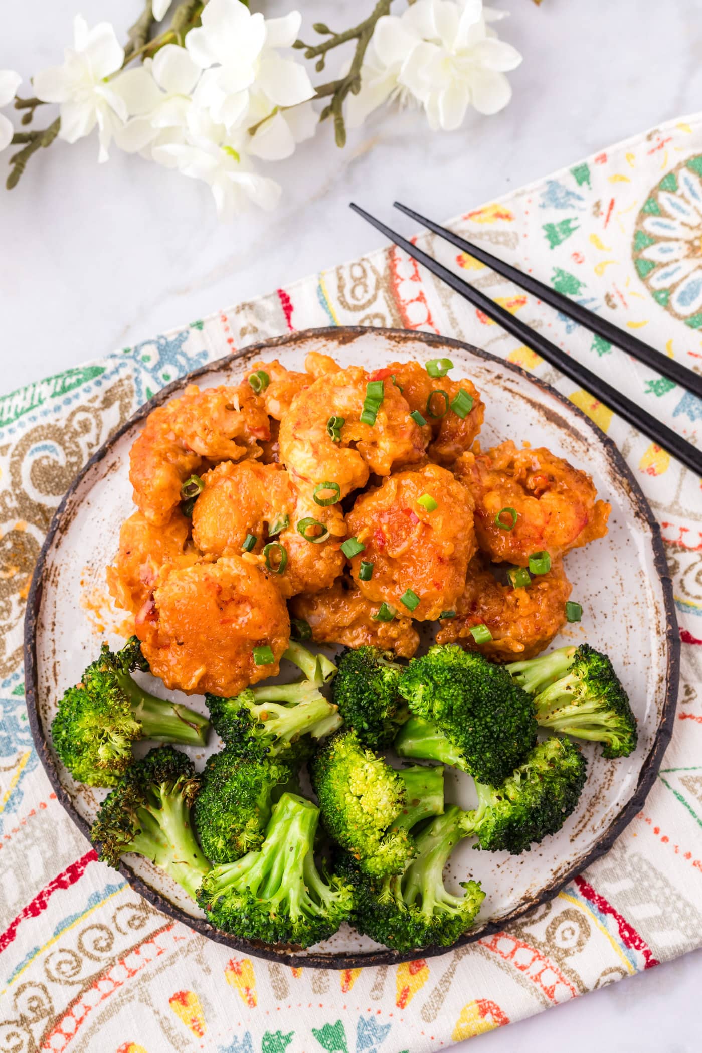 Bang Bang Shrimp on a plate with broccoli