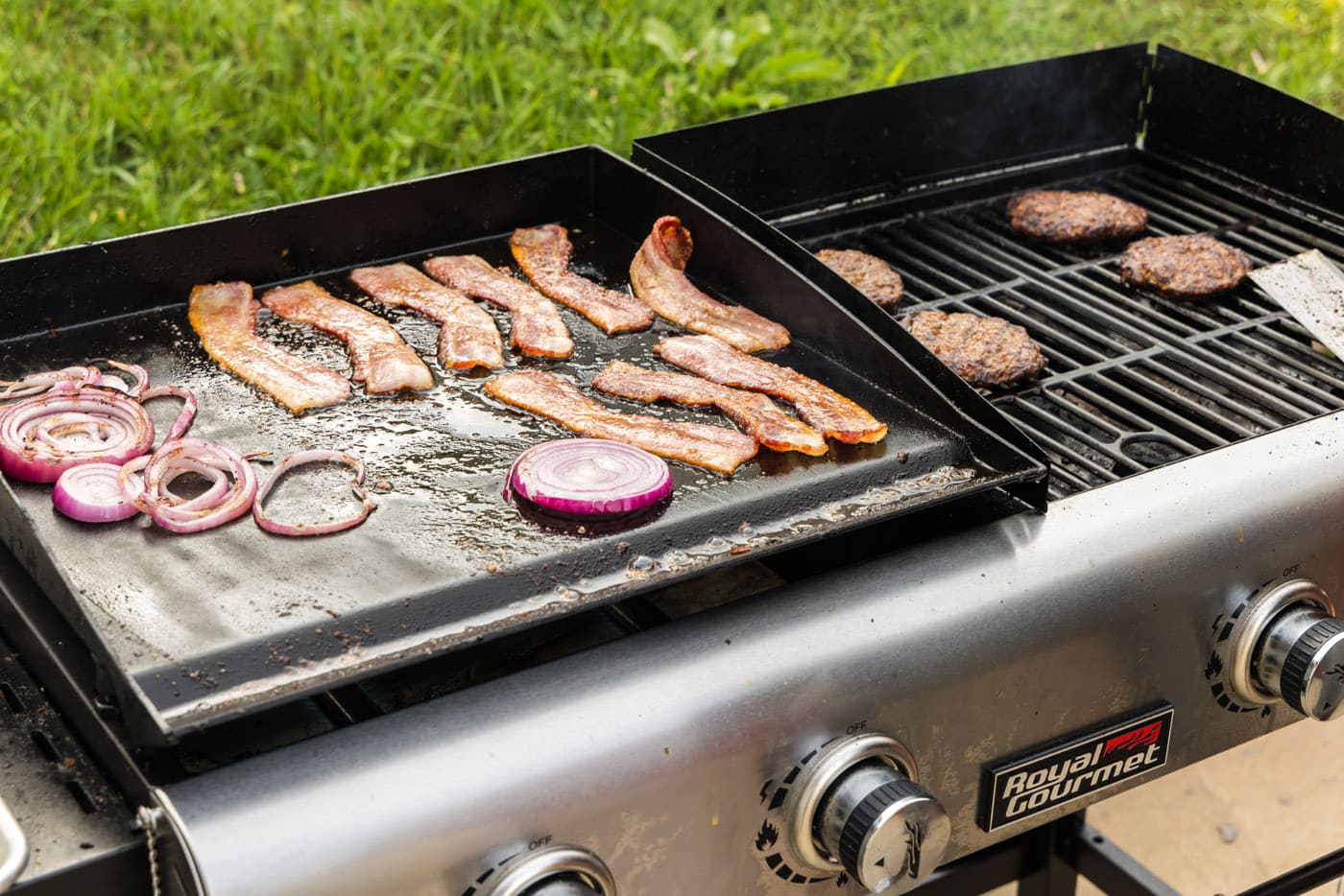 bacon and onion cooking on flat top grill