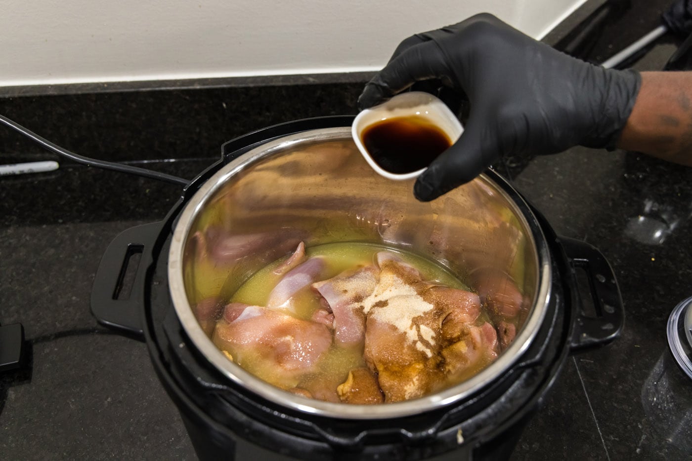 adding Worcestershire sauce to instant pot with chicken