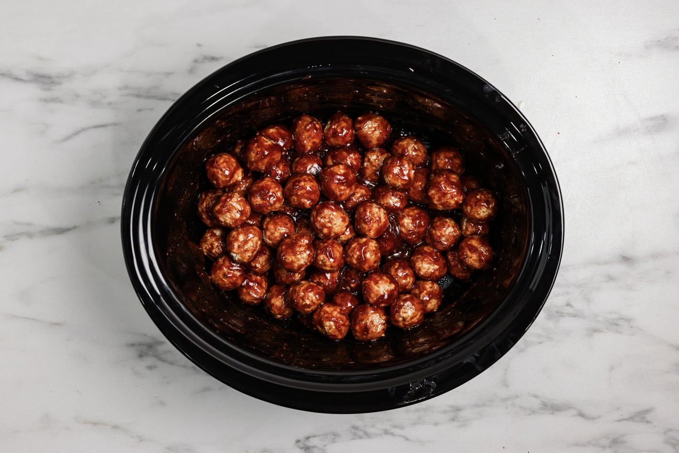Barbecue coated meatballs in a crockpot