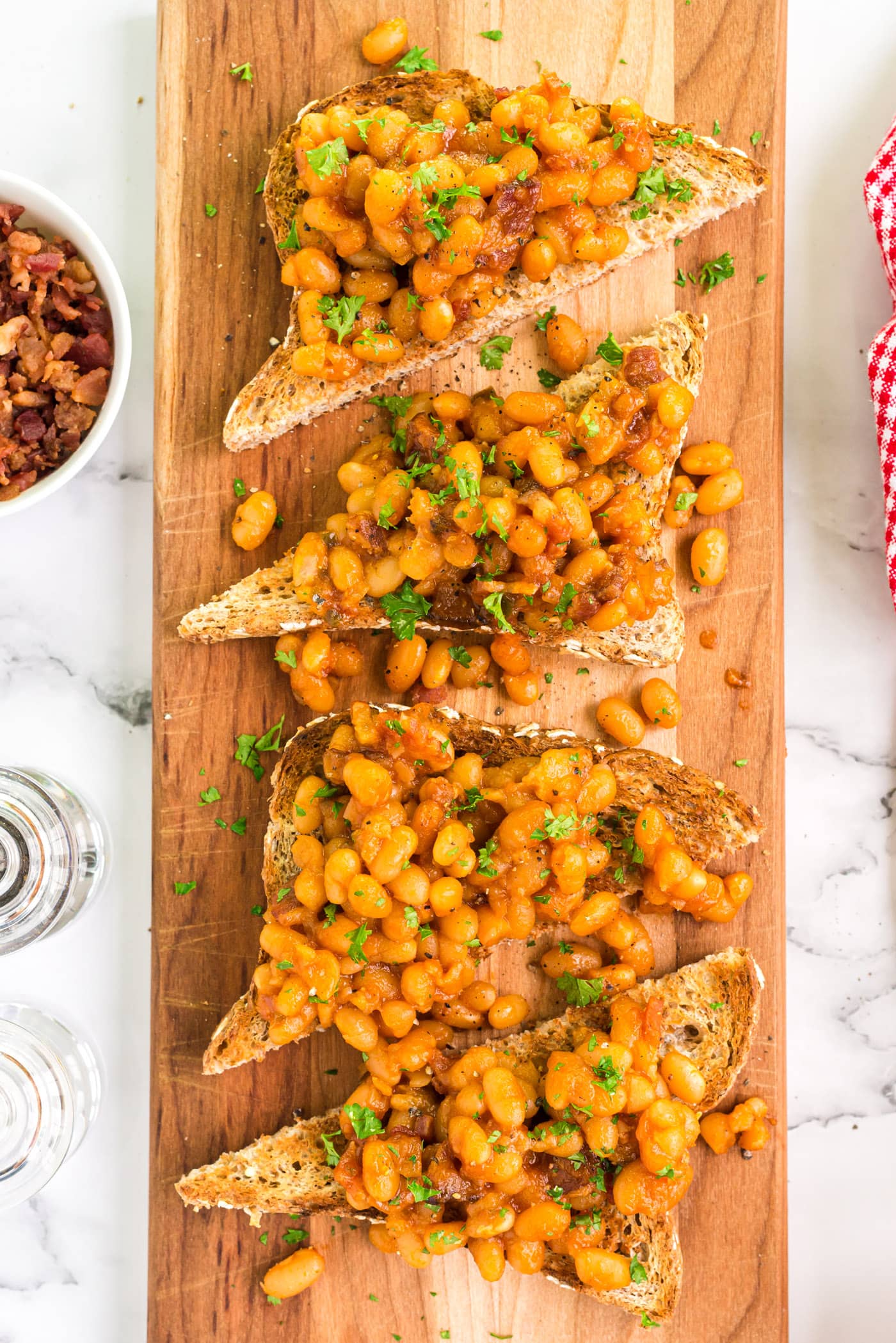 Overhead photo of Beans on Toast on a wooden serving platter