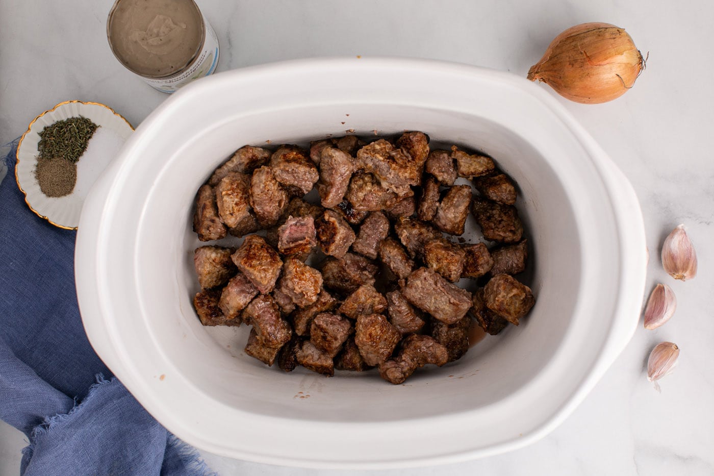 brown beef stew meat added to crockpot