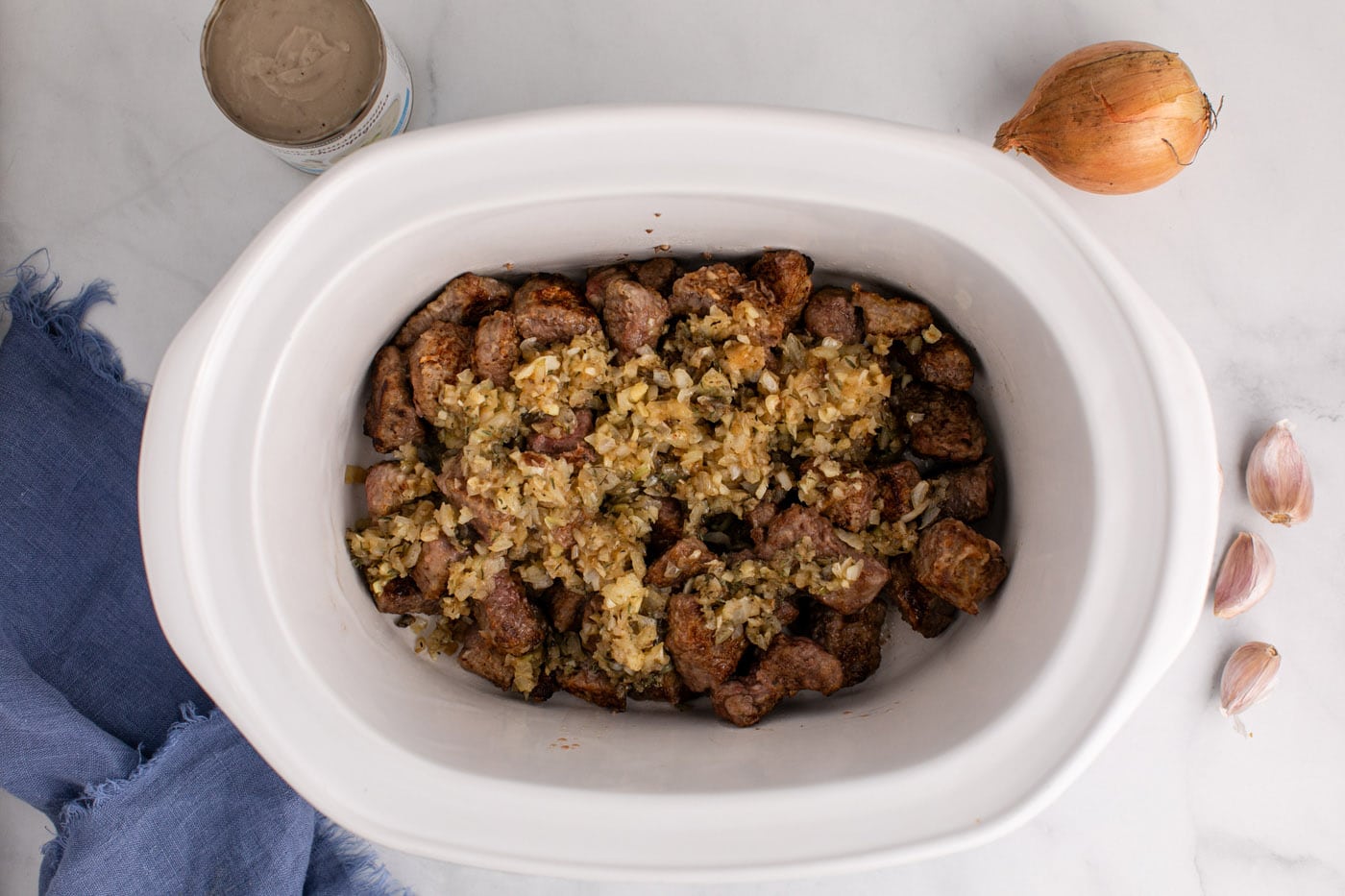 onion mixture added to crockpot with beef stew meat