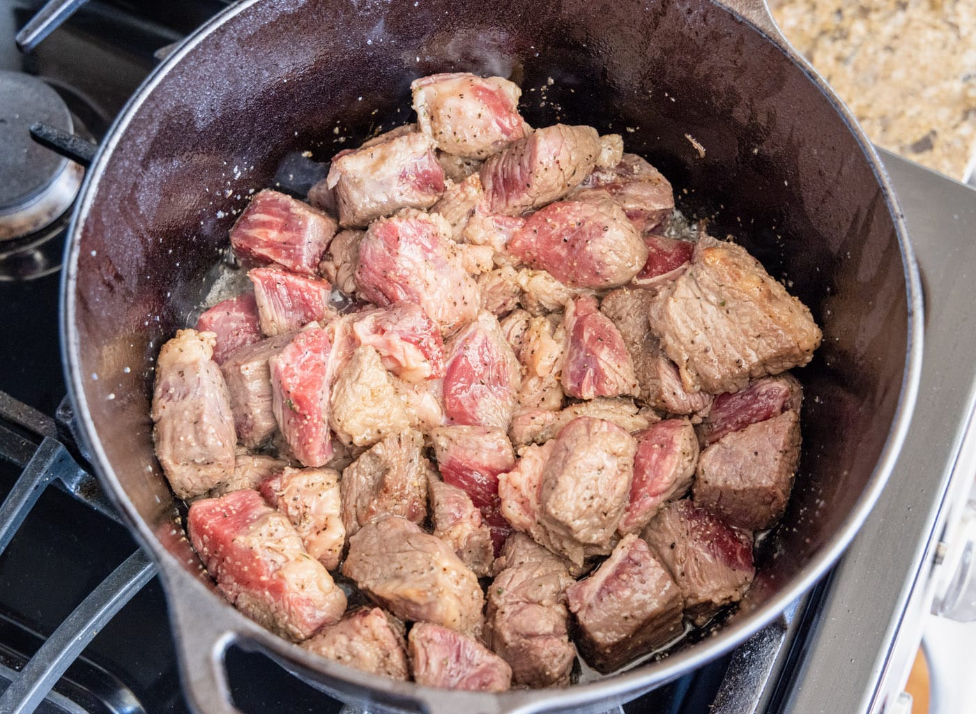 browned beef chuck in a dutch oven